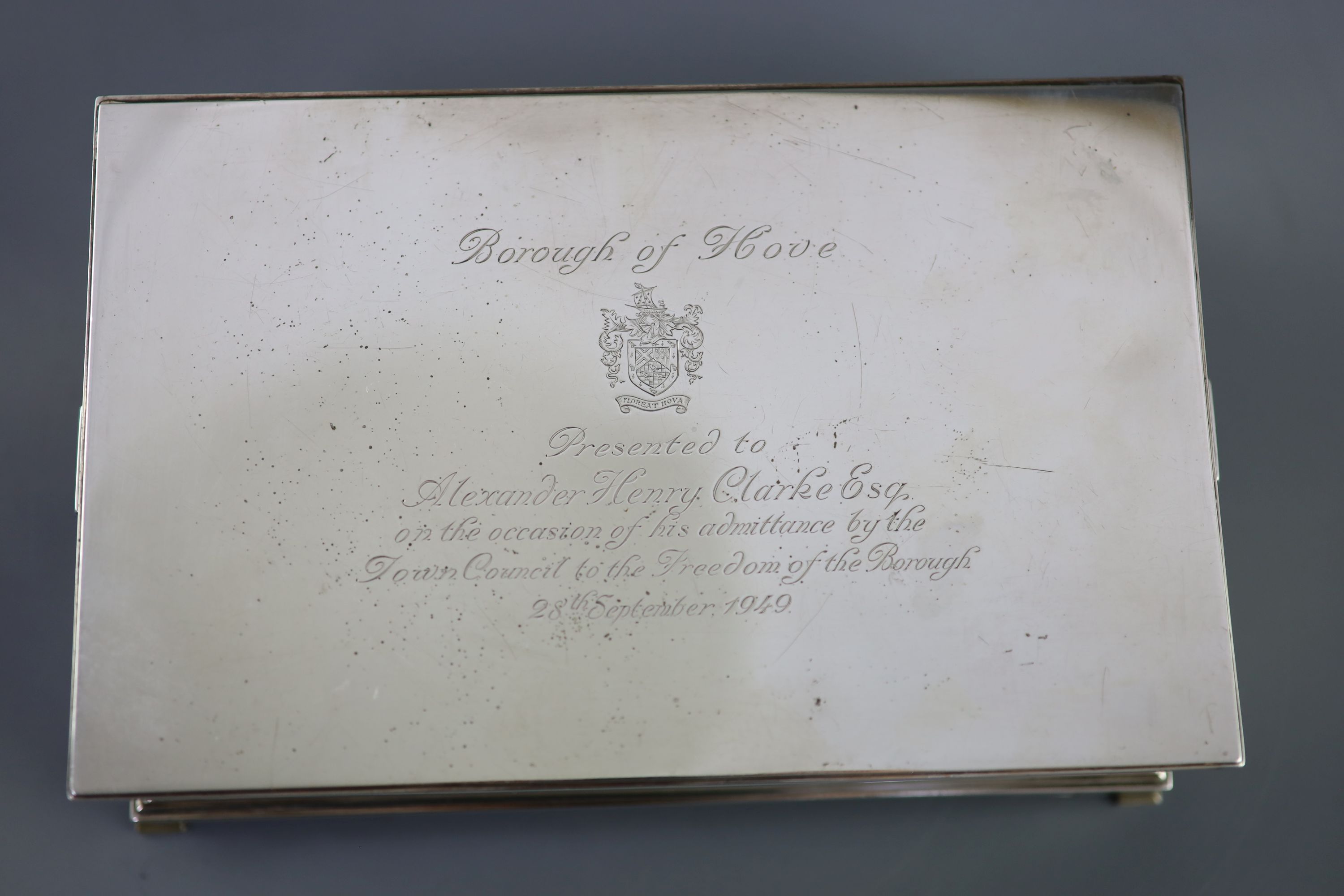 A George VI silver mounted two handled rectangular cigar box, by William Comyns & Sons Ltd, with engraved inscription relating to the Freedom of the Borough of Hove, awarded to Alexander Henry Clarke Esq.